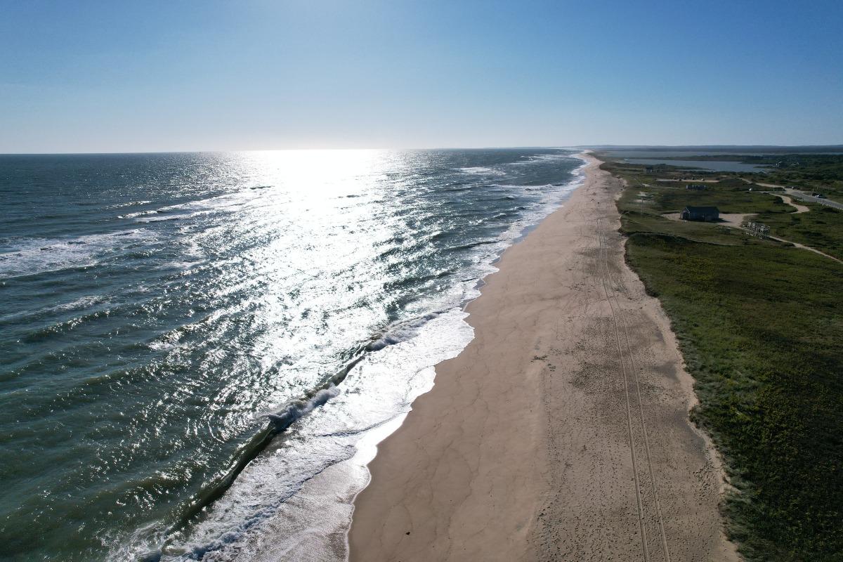 Aerial view of South Beach with serene ocean waves. Martha's Vineyard, Massachusetts. We have multiple rentals that are beachfront on Martha's Vineyard.